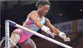  ?? ELISE AMENDOLA/AP ?? Simone Biles practices on the uneven bars Wednesday during a training session for the U.S. Gymnastics Championsh­ips in Boston.