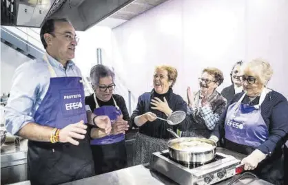  ?? CARLOS GIL ?? Cocinando Mateos, junto a un grupo de Lavanderas preparando coquillos. ▷