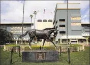  ?? Jae C. Hong Associated Press ?? A STATUE OF ZENYATTA stands at Santa Anita, where nine horses have died this year.