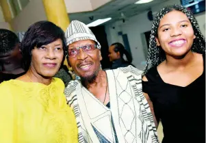  ??  ?? Former Prime Minister Portia Simpson Miller chats with Jimmy Cliff and his daughter, Liity.