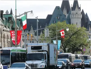  ?? FRED CHARTRAND/THE CANADIAN PRESS ?? Commuter traffic below Parliament Hill, is jammed by lane and road closures in front of Parliament Hill on Wednesday as preparatio­ns continue for Saturday’s Canada 150 party.