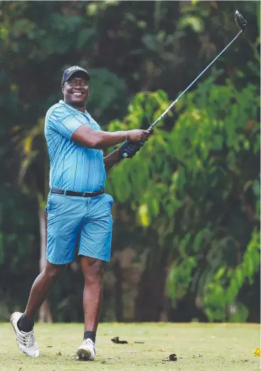  ?? Picture: BRENDAN RADKE ?? TESTING TIMES: Dumi Dlamini plays a round of golf with friends at the Cairns Golf Club.