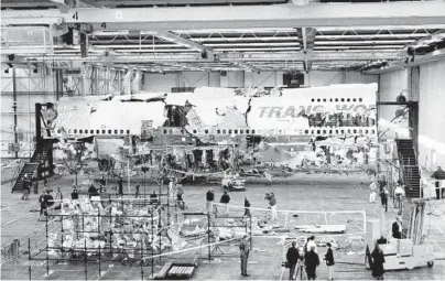  ?? VIC DELUCIA/THE NEW YORK TIMES ?? Wreckage recovered from TWA Flight 800 is assembled inside a hangar July 11, 1997, in Calverton, New York. The National Transporta­tion Safety Board has announced plans to decommissi­on and destroy the remaining wreckage.