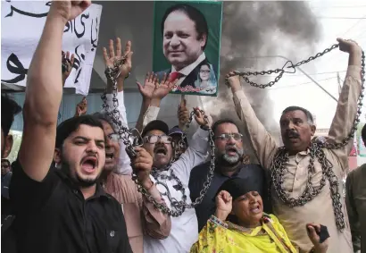  ?? AFP ?? supporters of PmL-n chant slogans during a protest in multan after a court decision against former prime minister nawaz sharif. —