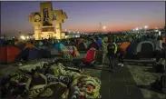  ?? (AP/Aurea Del Rosario) ?? Pilgrims camp outside the Basilica of Guadalupe early Monday in Mexico City. Devotees of the Virgin of Guadalupe make the pilgrimage for her Dec. 12 feast day, the anniversar­y of one of several apparition­s of the Virgin Mary an Indigenous Mexican man named Juan Diego witnessed in 1531.