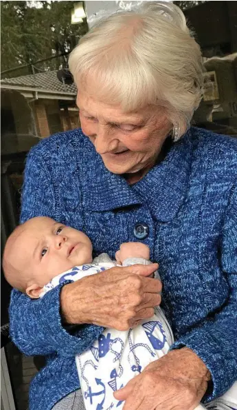  ?? Photo: Angela Johns ?? FACES LIGHT UP: Bateau Bay Bupa Aged Care resident June enjoys a cuddle with six-week-old baby Cooper.