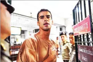  ??  ?? Hakeem al-Araibi, a Bahraini refugee and Australian resident, is escorted to a courtroom in Bangkok on Monday.