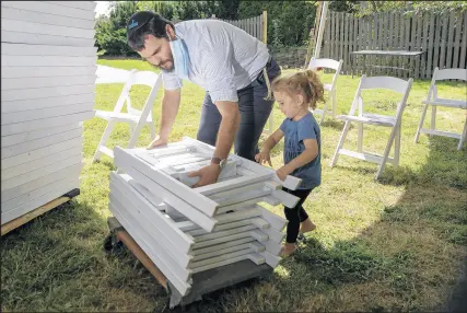  ?? MICHAEL GARD/POST-TRIBUNE ?? Rabbi Eliezer Zalmanov, of Chabad Lubavitch, sets up chairs for this weekend’s Rosh Hashana services.