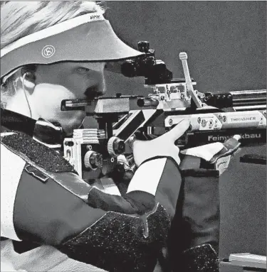  ?? SAM GREENWOOD/GETTY ?? Virginia Thrasher of the U.S. takes aim at the target en route to her gold-medal performanc­e in the 10-meter air rifle.
