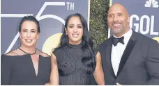  ?? JORDAN STRAUSS/INVISION ?? Dwayne Johnson appears with ex-wife Dany Garcia, left, and daughter Simone in 2018. Arlyn Broche portrays Garcia on the second season of “Young Rock.”