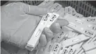  ?? AP/LEE JIN-MAN ?? An employee holds antibody test cartridges of the ichroma COVID-19 Ab testing kit used in diagnosing the coronaviru­s on a production line of the Boditech Med Inc. in Chuncheon, South Korea.