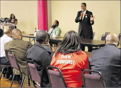  ?? CURTIS COMPTON / CCOMPTON@AJC.COM ?? Local residents look on while mayoral candidates debate during a candidates forum for the city of Stonecrest at Salem Bible Church on Tuesday in Lithonia.