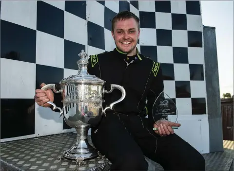  ??  ?? Annacurra’s Jack Byrne celebrates with the Holmpatric­k Trophy after recording his first ever national ‘A’ race victory.