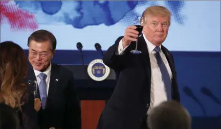  ?? ANDREW HARNIK — THE ASSOCIATED PRESS ?? U.S. President Donald Trump and South Korean President Moon Jae-in toast at the start of a dinner at the Blue House in Seoul, South Korea, Tuesday. Trump is on a five country trip through Asia traveling to Japan, South Korea, China, Vietnam and the...