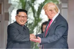  ?? PICTURE: XINHUA ?? WATERSHED GREETING: The leader of North Korea, Kim Jong-un, meets US President Donald Trump in Singapore yesterday.