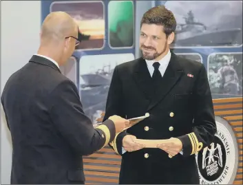  ??  ?? TOP STUDENT Lt Cdr Roberts (right) receives the award from Flotillena­dmiral Christian Bock