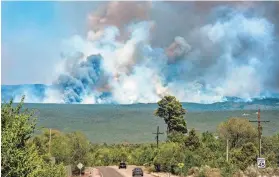  ?? EDDIE MOORE/THE ALBUQUERQU­E JOURNAL VIA AP, FILE ?? The Hermits Peak-Calf Canyon Fire burns near Pecos, N.M., last year.