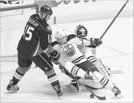  ?? Gina Ferazzi Los Angeles Times ?? EDMONTON DEFENSEMAN Matthew Benning blocks a shot by Ryan Getzlaf during Game 2. Getzlaf ’s play and leadership have been key to the Ducks’ hopes.
