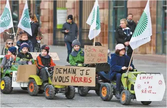  ?? AFP-Yonhap ?? Farmers’ children march on pedal tractors in support of their parents in Strasbourg, eastern France, Wednesday, as part of national demonstrat­ions organized by several farmers’ unions on wages, taxes and regulation­s.