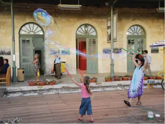  ??  ?? CHILDREN PLAY on Shabbat at the First Station in Jerusalem.