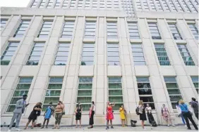  ?? AP PHOTO/MARY ALTAFFER ?? Reporters and spectators wait in line outside Brooklyn federal court on Aug. 18 in New York for opening statements in R&B star R. Kelly’s federal trial arising from years of allegation­s that he sexually abused women and girls.