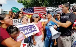  ?? ASSOCIATED PRESS ?? IMMIGRATIO­N RIGHTS ACTIVISTS CHANT ANTI-TRUMP SLOGANS as they urge Republican lawmakers in Florida to firmly oppose President Donald Trump’s proposals to increase funding for immigratio­n enforcemen­t as deadlines for budget decisions near in Congress on...