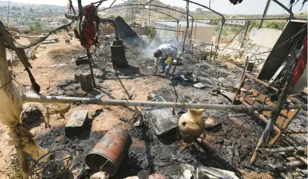  ?? JAAFAR ASHTIYEH/GETTY-AFP ?? A Palestinia­n inspects his damaged belongings Saturday in Al Mughayir in the West Bank.