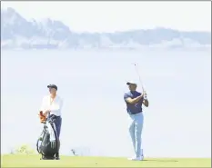  ?? Andrew Redington / Getty Images ?? Tiger Woods waits with caddie Joe LaCava on the eighth hole during a practice round for the U.S. Open at Pebble Beach on Monday.