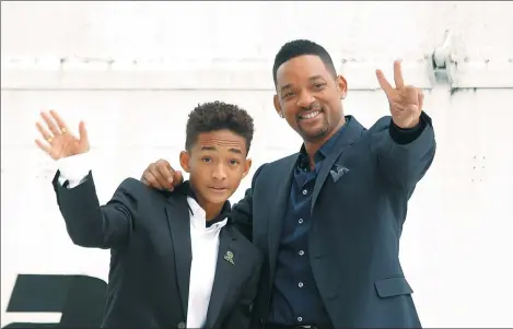  ?? IVAN BURNYASHEV / REUTERS ?? Will Smith and his son Jaden Smith pose for pictures during a photo call in Moscow.