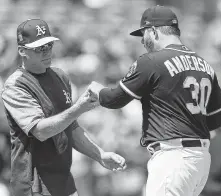  ?? Thearon W. Henderson / Getty Images ?? A’s manager Bob Melvin’s job of piecing together a rotation became more difficult when Brett Anderson, right, who lost to the Astros on Monday, went on the disabled list Tuesday.