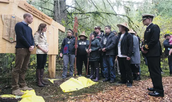  ?? JONATHAN HAYWARD/THE CANADIAN PRESS ?? The Duke and Duchess of Cambridge listen to First Nations members after a plaque unveiling Monday in the Great Bear Rainforest in Bella Bella.