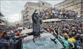  ?? Ben Curtis ?? The Associated Press Kenyan opposition leader Raila Odinga gestures to supporters gathered Sunday in Nairobi, Kenya. Odinga condemned police killings of rioters during protests after the country’s disputed election and is urging supporters to skip work...