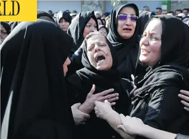  ?? EBRAHIM NOROOZI / THE ASSOCIATED PRESS ?? Families mourn the victims of Saturday’s terror attack on a military parade in the southwest Iranian city of Ahvaz, which killed 25 people, at a mass funeral ceremony on Monday.