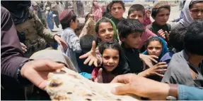  ?? Photo: AP ?? Afghans queue up for food aid at a camp after the country’s deadliest earthquake in two decades.