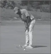  ??  ?? St. Charles High School senior Zach Spann taps in on No. 18 to complete a round of 86 on Wednesday morning in the Charles County Golf Championsh­ips at White Plains Golf Course, which was good for seventh overall