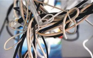  ?? GETTY IMAGES ?? Tangled electronic cords don’t just look messy, they can also be a safety hazard. Learn which products can help you safely conceal them.