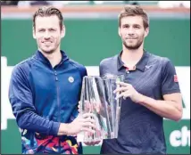  ?? ?? Nikola Mektic, of Croatia, (right), and Wesley Koolhof, of the Netherland­s, hold the trophy after defeating Marcel Granollers, of Spain, and Horacio Zeballos, of Argentina in the doubles final match at the BNP Paribas Open tennis tournament in Indian Wells, Calif. (AP)