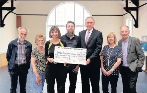  ??  ?? Paul Geddes and his wife Tracey Geddes from Paul Geddes Wealth Management in Leicester, third and second from right, presented a cheque for £1,000 to Earl Shilton Stute supporters and committee members, from left, Paul Statham, Rosemary Coe, Julia...