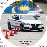 ??  ?? Timed slalom challenge Rear-ing to go in the BMW 420i Coupé Sport