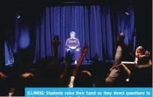  ??  ?? ILLINOIS: Students raise their hand as they direct questions to Holocaust survivor Adina Sella as she is displayed on a threedimen­sional hologram.