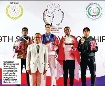  ?? CAMSOC ?? Cambodian Karate exponent Sreang Virak (second left) is presented with a gold medal after defeating Malaysia’s S Gnanasekar­an Kathish.