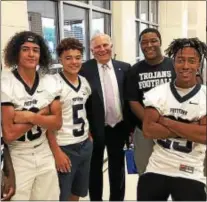  ?? PHOTO COURTESY OF STEPHEN RODRIGUEZ ?? State Sen. Robert Mensch, center, is thanked by members of the Pottstown High School football team for providing a $250,000 grant to help pay to replace the lights at Grigg Memorial Field and return Friday night football to Pottstown.