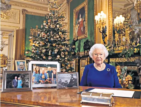  ??  ?? The Queen addresses the nation alongside pictures of past and future kings – George VI, the Prince of Wales and the Duke of Cambridge – as well as the Duke of Edinburgh