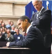  ?? Gerald Herbert / Associated Press 2009 ?? President Barack Obama signs the American Recovery and Reinvestme­nt Act Feb. 17, 2009.