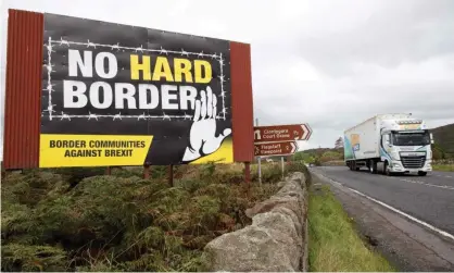  ?? Photograph: Paul Faith/AFP/Getty Images ?? A lorry passes a billboard in Newry, Northern Ireland, on 1 October 2019. ‘Mr Johnson … signed the UK up to the EU’s state aid regime … as a quid pro quo to allow the province to maintain frictionle­ss trade with the bloc, and to avoid a border on the island of Ireland.’