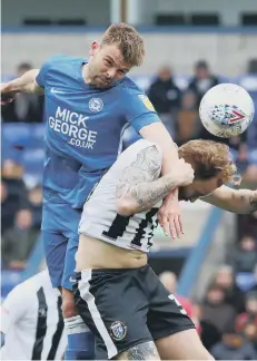  ??  ?? Posh substitute Matt Godden wins a header against Gillingham.