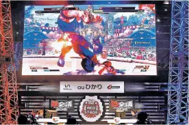  ?? KYODO NEWS VIA AP ?? Competitor­s play Street Fighter during the esports event Saturday at Makuhari Messe hall in Chiba near Tokyo. Although Japan is the home of game giants like Nintendo, Sony and Bandai Namco, massive game fans as well as individual star game players,...