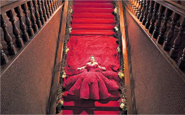  ??  ?? Isabelle Duterte, the granddaugh­ter of the president of the Philippine­s, poses in a red ball gown on the stairs of Malacañang Palace, drawing comparison­s to Imelda Marcos who was infamous for her vast shoe collection