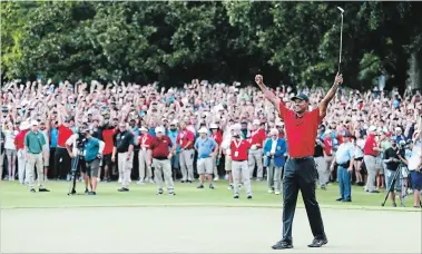  ?? GETTY IMAGES FILE PHOTO ?? Tiger Woods celebrates making a par on the 18th green to win the Tour Championsh­ip at East Lake Golf Club in Atlanta,Ga., in September.