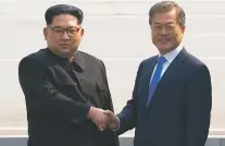  ?? KOREA BROADCASTI­NG SYSTEM VIA AP ?? North Korean leader Kim Jong Un, left, shakes hands with South Korean President Moon Jae-in as Kim crosses the border Friday into South Korea for their historic face-to-face talks in Panmunjom.